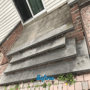 An outdoor patio with brick steps leading up to a sliding door shows signs of wear, dirt, and weeds growing between the bricks. The steps and the tiled area at the top are discolored. The word "Before" is written in blue at the bottom center of the image, highlighting the need for paver sealing in Nassau County.